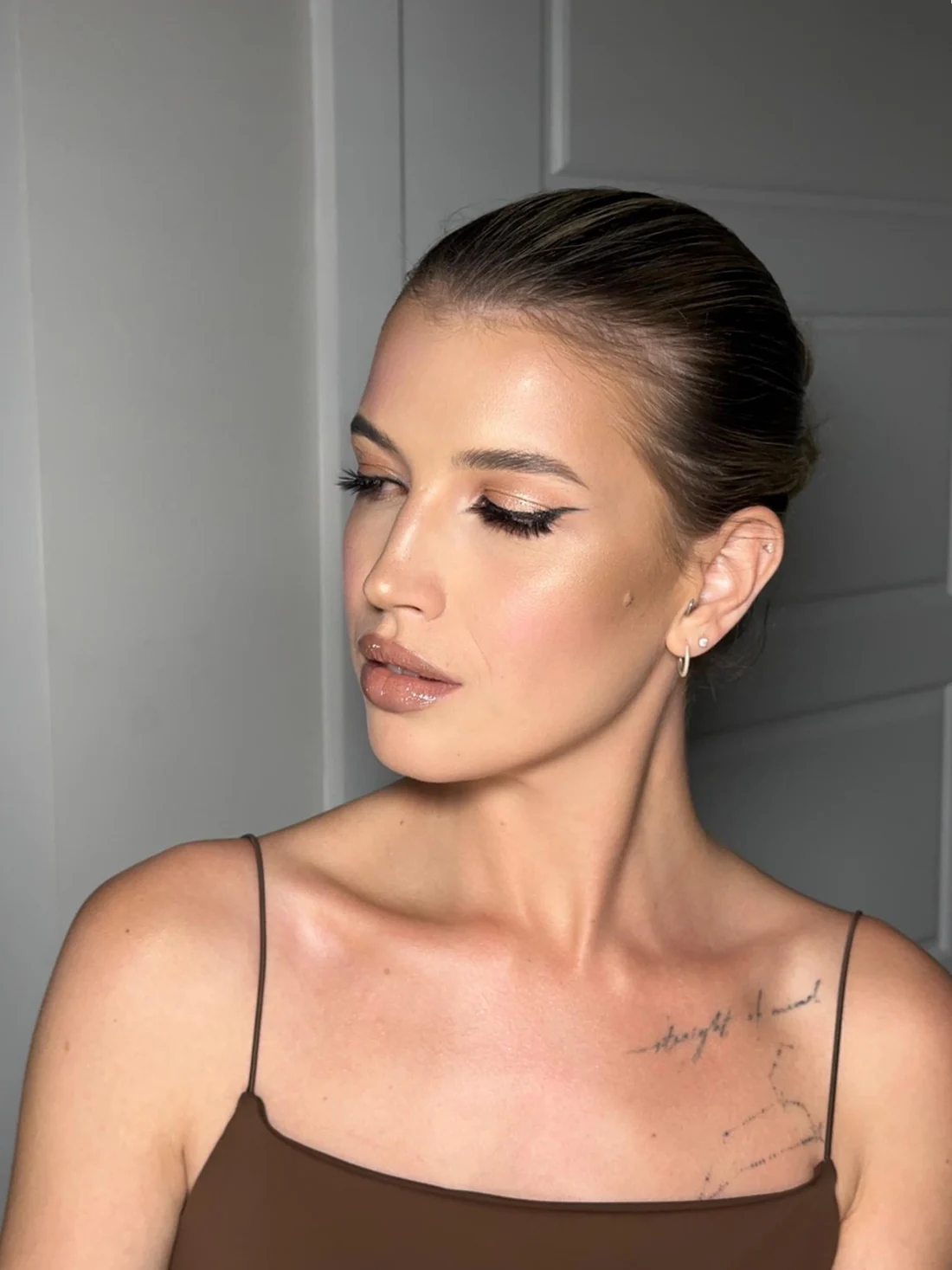 Soft neutral makeup with a sleek updo
